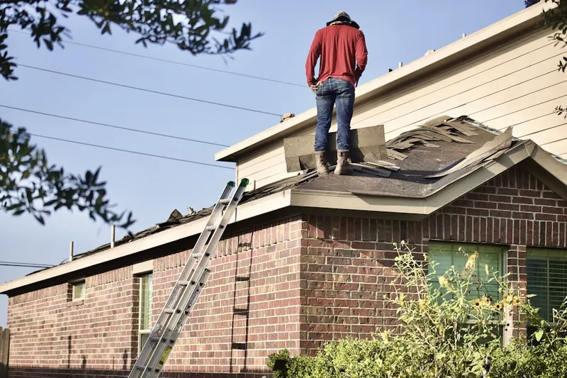 Professional roofer working on a residential roof in Penn State Campus